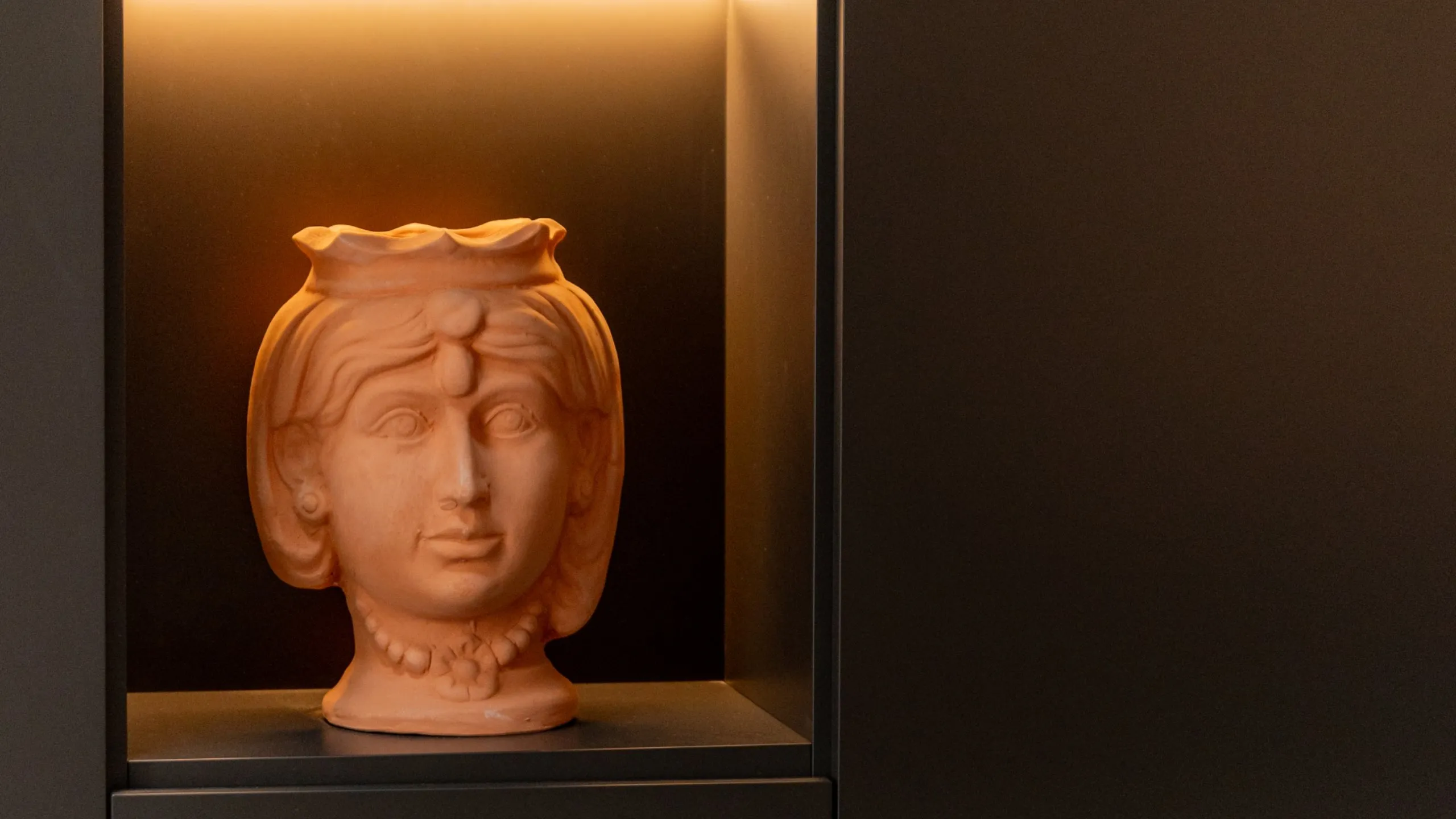 Testa di Moro in terracotta naturale, dettaglio d'arredo scultoreo nella Suite Sitwell a Villa Conrad.