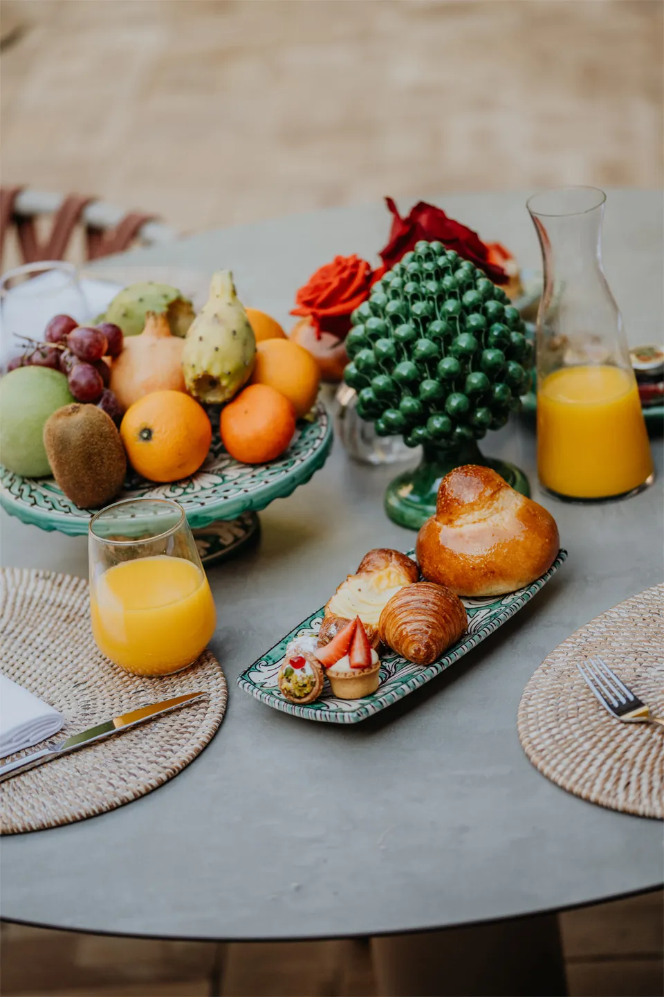Colazione siciliana a Villa Conrad: brioche col tuppo, pasticceria, spremuta e ceramiche artistiche di Taormina.